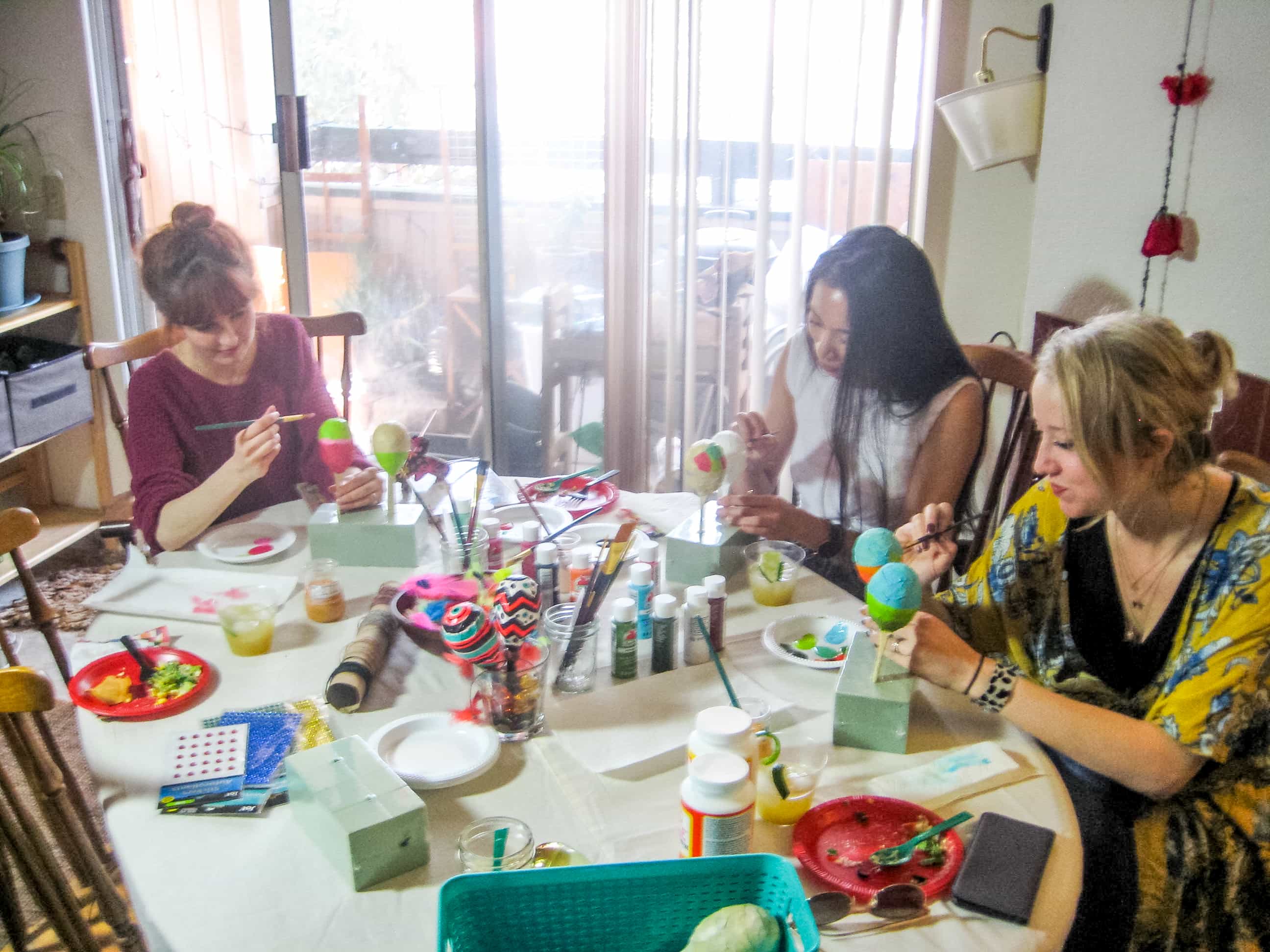 Photo of girls painting maracas at craft table