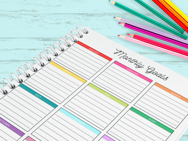 Featured image showing the printed monthly goal tracker ready to use!